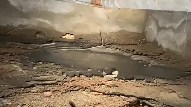 exposed supply lines under a Pinery crawl space with vapor barrier visible