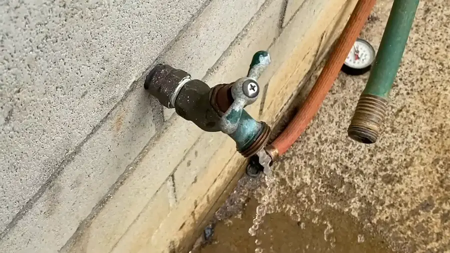 pressure regulator valve at the house entry with gauge reading in a Stonegate utility room