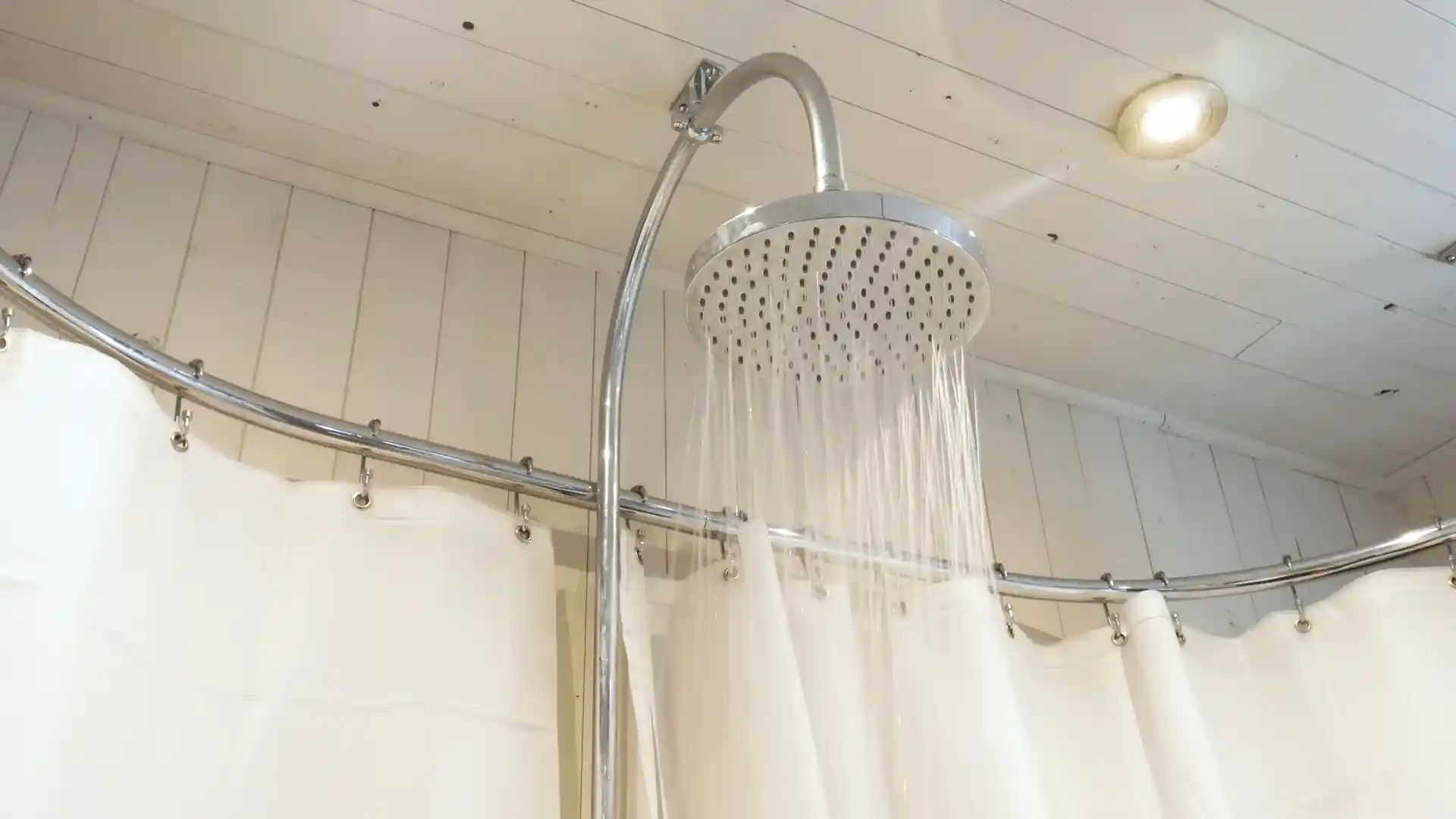 shower pan flood test with drain plug installed in a Pinery 1970s master bathroom